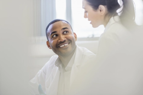 Healthcare - Male doctor smiling at female doctor 
