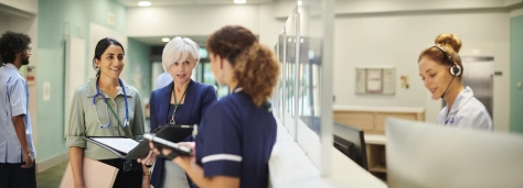 Healthcare - Medical professionals talk in hospital hallway