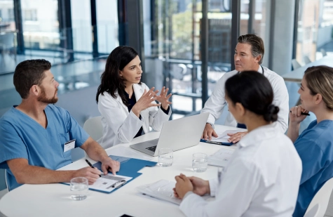 Healthcare - medical team meeting with multiple doctors 