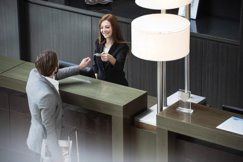 People - Female receptionist smiling at businessman 