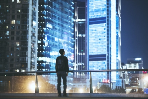 People - Man looking at cityscape at night