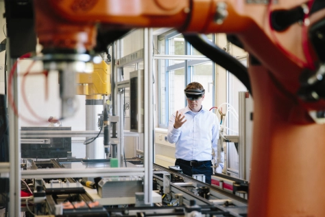 Tech - Engineer places a virtual robotic arm into the production line
