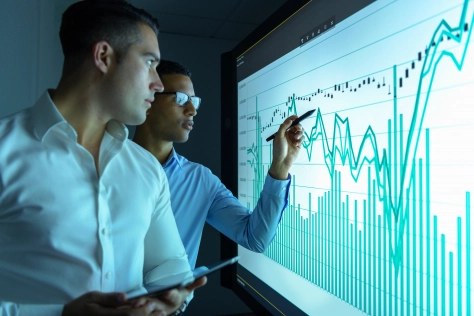 Business-Men-analyzing-data-chart-973708488.jpg