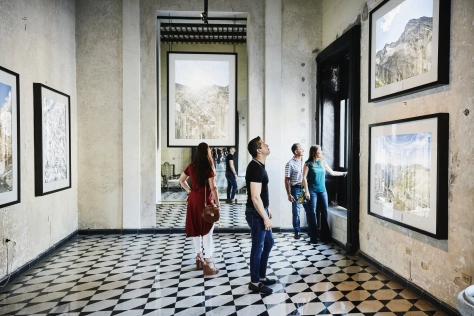 People-people in art exhibit looking at paintings 