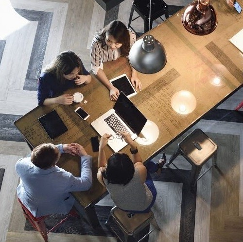 People - team around table - non-traditional office - 500x500