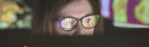 People - Woman with glasses looking at computer 501x157