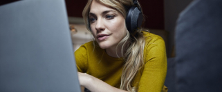 Digital - woman with headphones and laptop - 1200x500