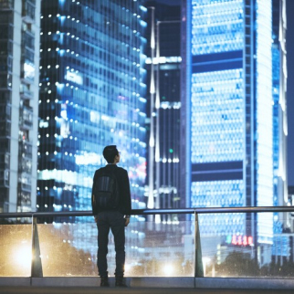 People-Man-looking-at-cityscape-at-night-500x500